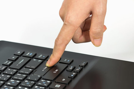 Close-up of typing female hands on keyboard enter selective focus