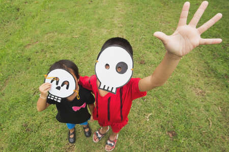 Poor kids want to play Halloween with the mask handmade selective focusの写真素材