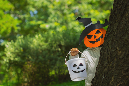 Poor kids play Halloween with the mask handmadeの写真素材