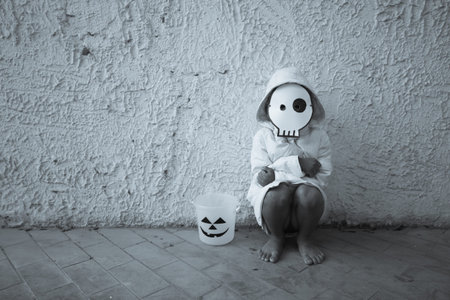 Poor kid waiting for Halloween candy BW tone,focus to maskの写真素材