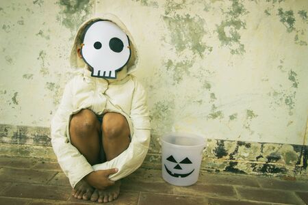 Poor kid waiting for Halloween candy vintage dark toneの写真素材