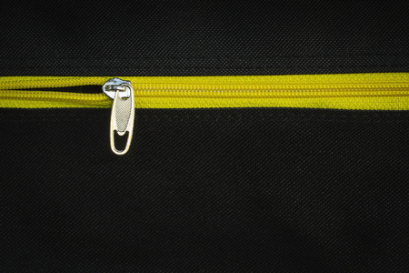 Zip yellow on black cloth.の写真素材