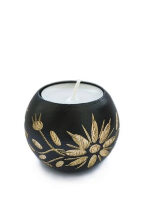 Candle in carved wooden candlestick isolated over whiteの写真素材