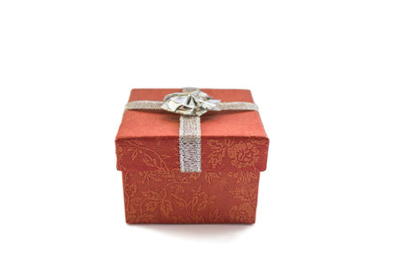 Red box with silver ribbon isolated over whiteの写真素材
