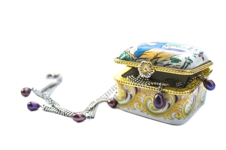 Little enamelled chinese box with jewelry over whiteの写真素材