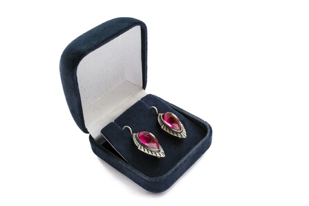 Pink tourmaline earrings in a velvet box isolated over whiteの写真素材