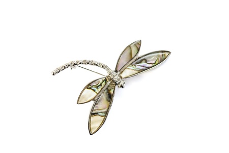 Nacre brooch in the form of dragonfly isolated over whiteの写真素材