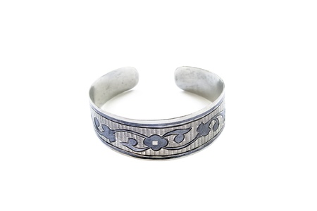 Silver vintage bracelet with black pattern isolated over whiteの写真素材