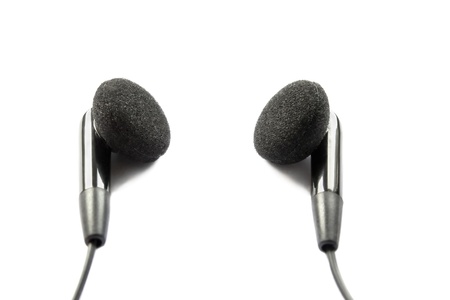 Black wired earphones isolated over white backgroundの写真素材
