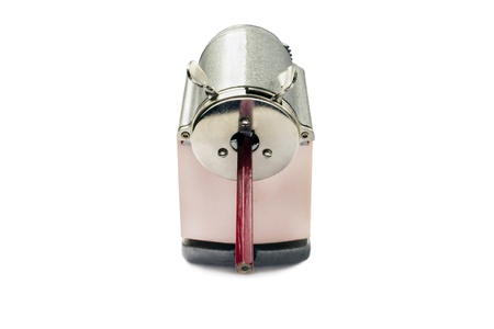 Vintage sharpener with pencil inside isolated over whiteの写真素材