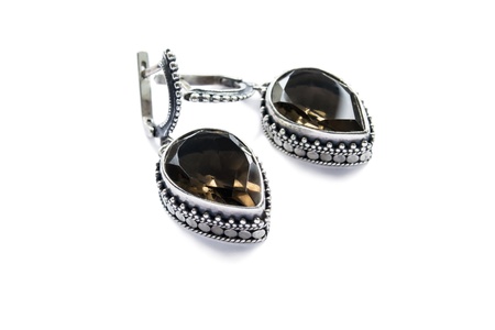 Vintage silver earrings with big faceted morion isolated over whiteの写真素材