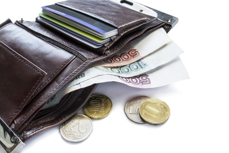 Opened leather wallet with credit cards and rouble coins and banknotes of different valuesの写真素材