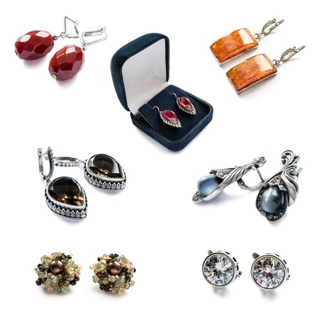 Set of silver earrings with different gemstones over whiteの写真素材