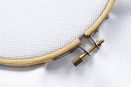 Part of wooden hoop with metal screw lock with blank white canvas on itの写真素材