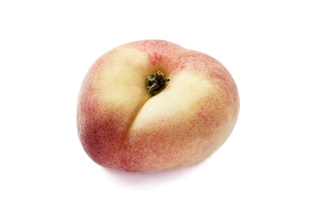 Juicy fresh rosy flat peach isolated over white backgroundの写真素材