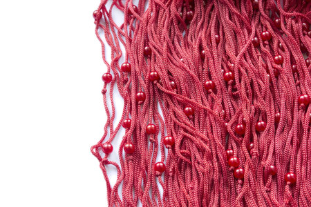 Red silky laces with some red beads on white background