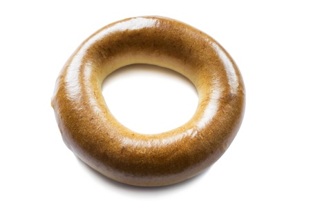 Fresh soft golden bagel isolated on white backgroundの写真素材