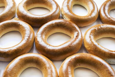 Some fresh delicious golden bagels as a backgroundの写真素材