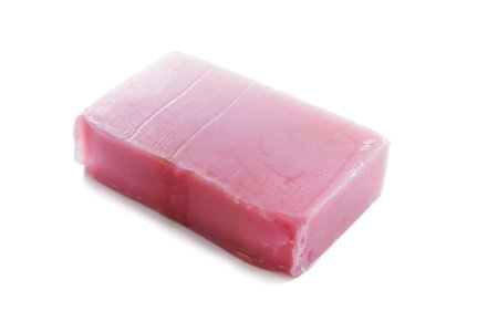 Piece of natural fruit pink soap on white background