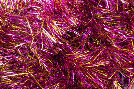 Garlands of pink christmas tree tinsel as a background