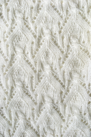 White openwork mohair knitting as a backgroundの写真素材