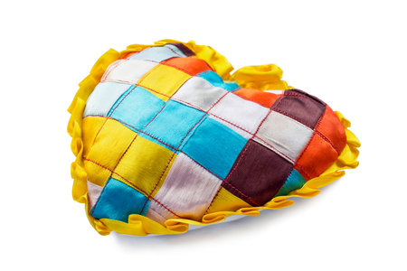 Little patchwork cushion in the form of heart on white backgroundの写真素材