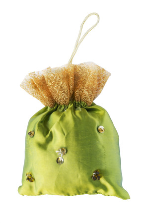 Handmade silk sachet bag decorated with lace and bead on white backgroundの写真素材