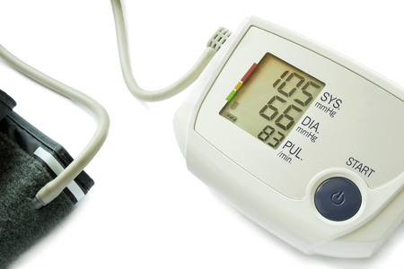 Electronic blood pressure monitor with cuff on white backgroundの写真素材