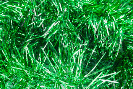 Garlands of green christmas tree tinsel as a backgroundの写真素材