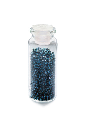 Blue beads in little glass jar isolated over whiteの写真素材