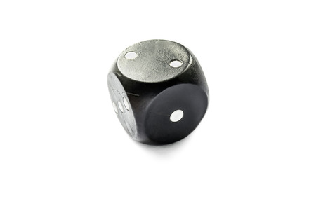 Simple old black dice isolated over whiteの写真素材