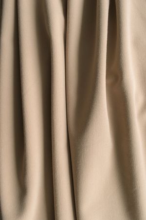 Beige cotton curtain drapery closeup as a backgroundの写真素材