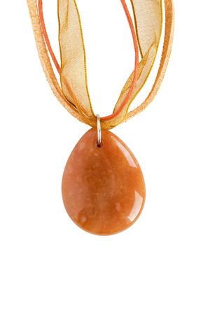 Simple amber pendant drop shaped on lace isolated over whiteの写真素材