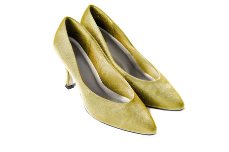 Golden silky high heels shoes on white backgroundの写真素材
