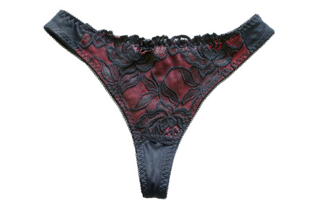 Red and black lacy panty on white backgroundの写真素材