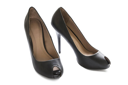 Glamour black leather stiletto heels shoes isolated over whiteの写真素材