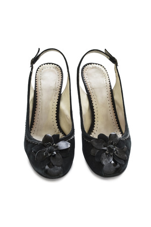 Black velvet slingbacks with big flower isolated over whiteの写真素材