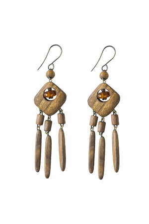 Wooden earrings with piece of amber isolated over whiteの写真素材