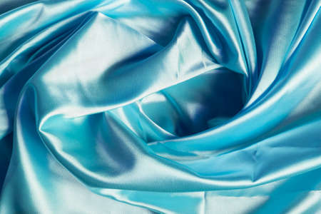 Draped blue satin as a backgroundの写真素材