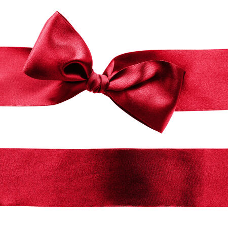 Red decorative satin ribbon with a bow on white backgroundの写真素材