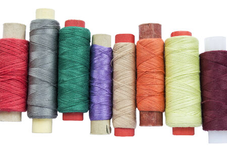Bobbins of multicolor threads on white backgroundの写真素材