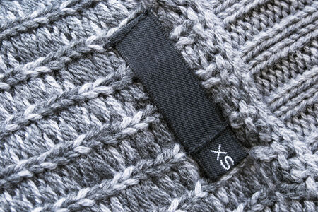 Blank label with XS size on gray wool sweaterの写真素材