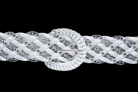 White braided belt with silver beads isolated over blackの写真素材