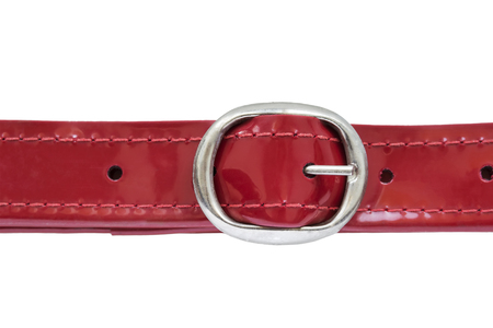 Red leather belt with silver buckle isolated over whiteの写真素材