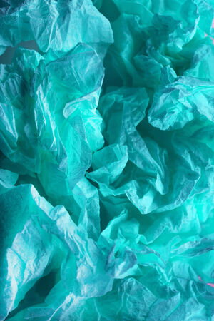 Abstract cyan crumpled paper as a backgroundの写真素材