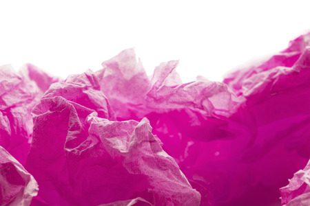 Pink crumpled paper on white abstract as a backgroundの写真素材