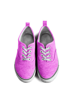 Pink textile sneakers isolated over whiteの写真素材