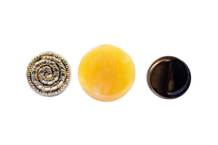 Metal and plastic yellow buttons on white backgroundの写真素材