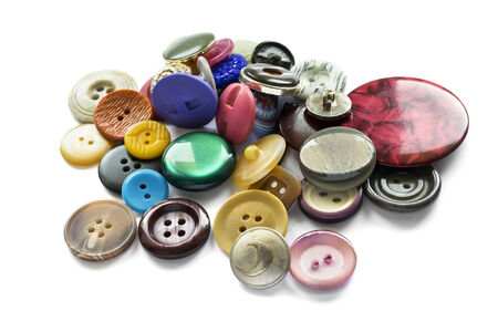 Pile of different colorful buttons isolated over whiteの写真素材
