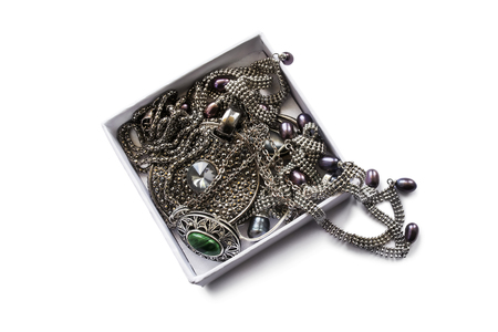 Silver jewels in a white box isolated over whiteの写真素材